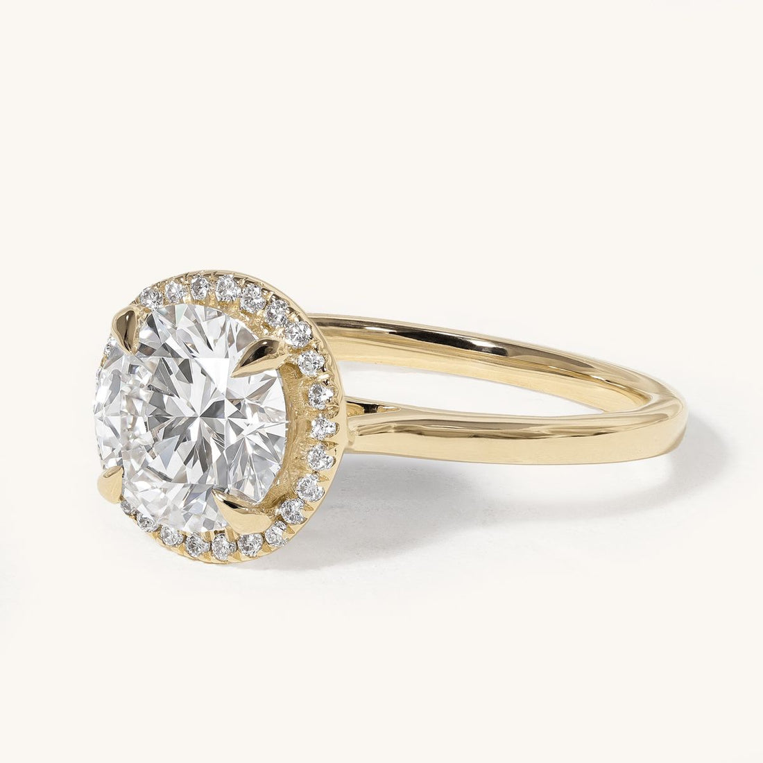 aideen_round_claw_solitaire_halo_cathedral_engagement_ring_01