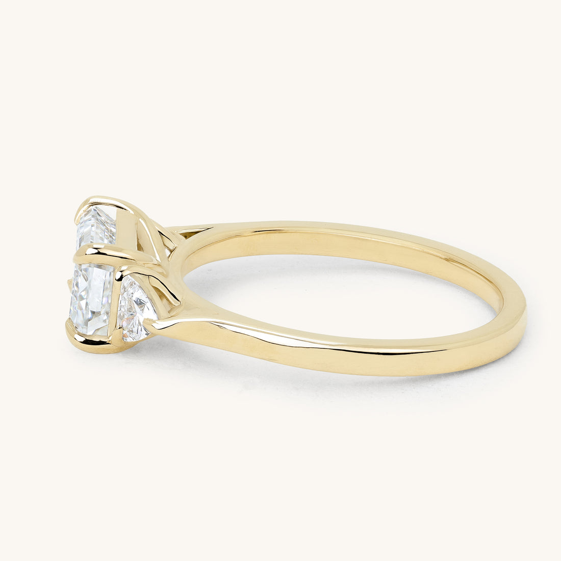 1.59ct East-West Emerald Claw Trilogy with Trillion Accent Engagement Ring